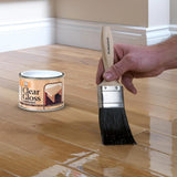 151 Clear Gloss Varnish Paint in tin with a brush applying varnish on wooden flooring