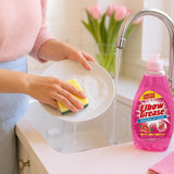 Person washing a plate with Elbow Grease Pink Blush washing up liquid at a kitchen sink