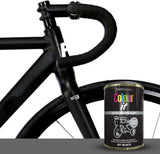 Jet black gloss paint tin from Paint Factory beside a sleek black bicycle frame