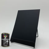 Jet black gloss paint tin from Paint Factory next to a black display board for colour comparison