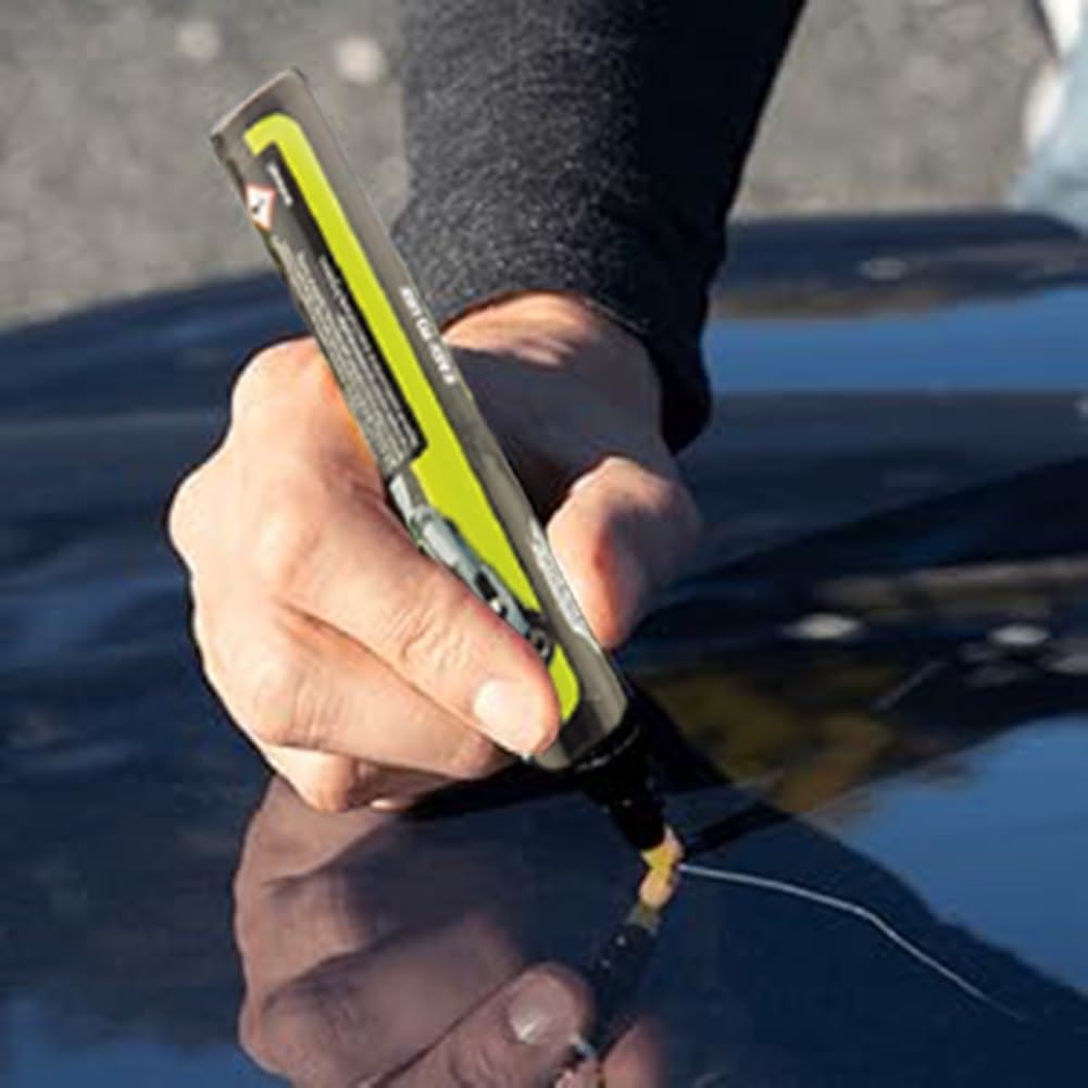 Person using a car scratch remover pen to repair a scratch on a vehicle's surface