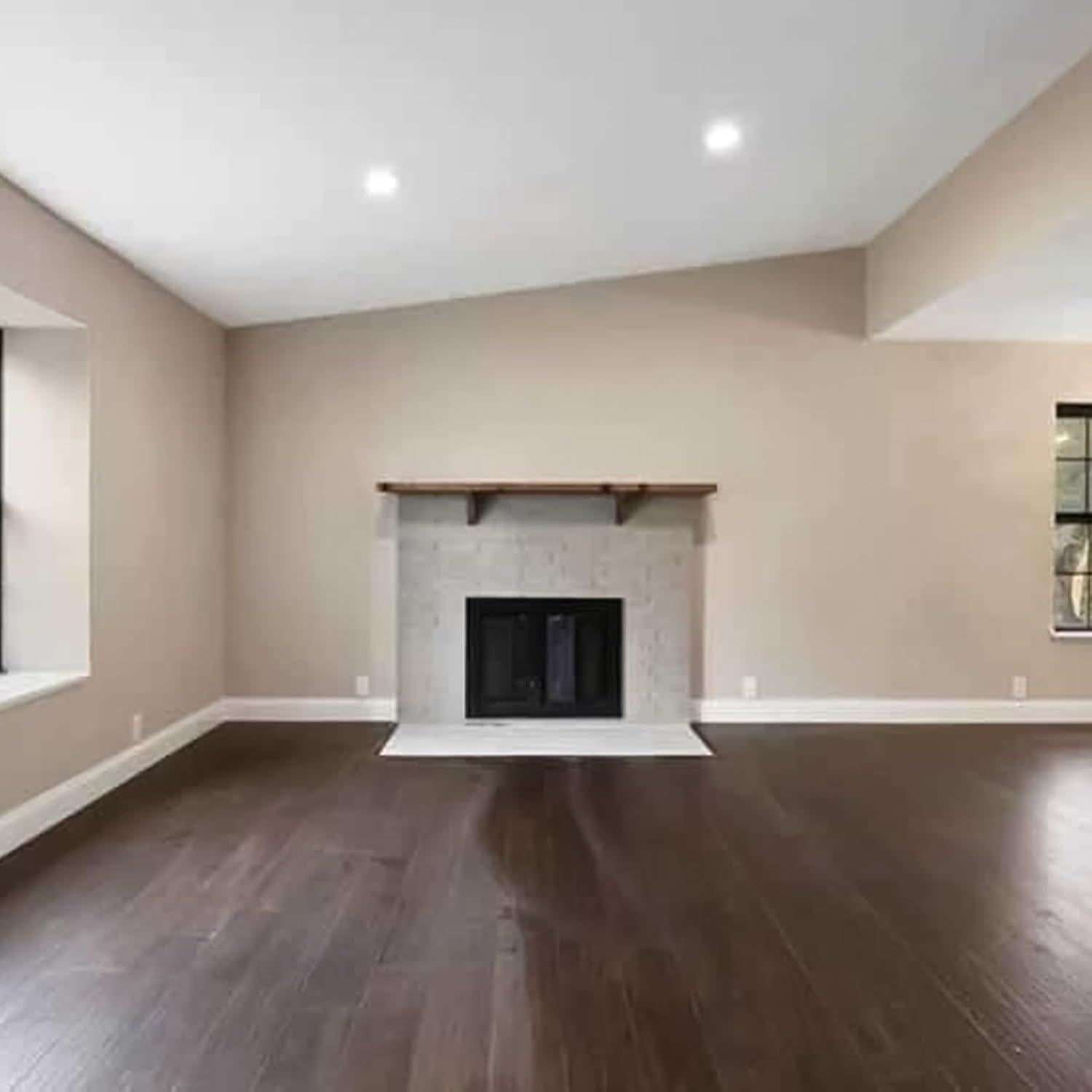 Living room showcasing dark oak varnish paint on wooden flooring and neutral walls