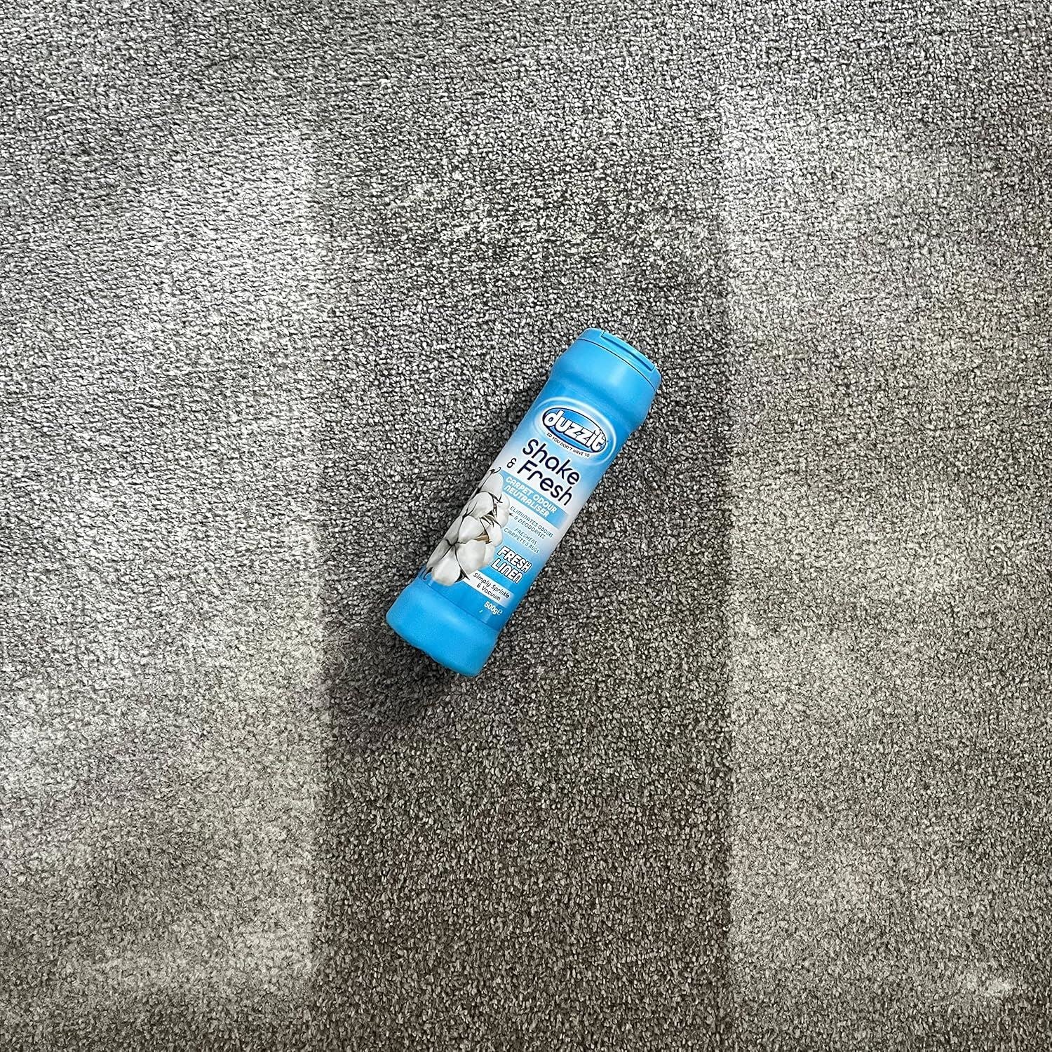 Duzzit Shake and Fresh Carpet Odour Neutraliser Fresh Linen in a blue container on grey carpet