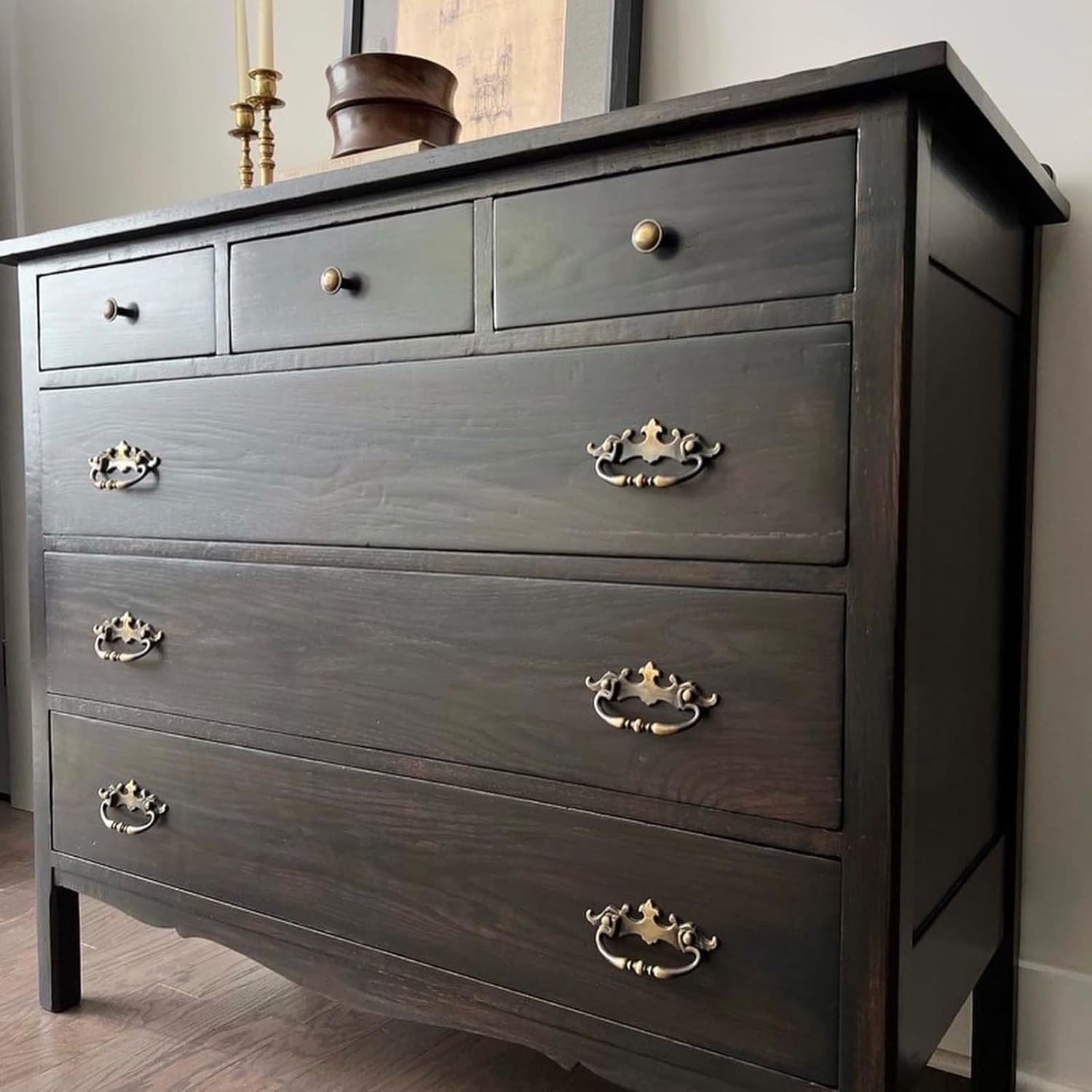 151 Nonslip black paint tin next to a stylish wooden chest of drawers with brass handles