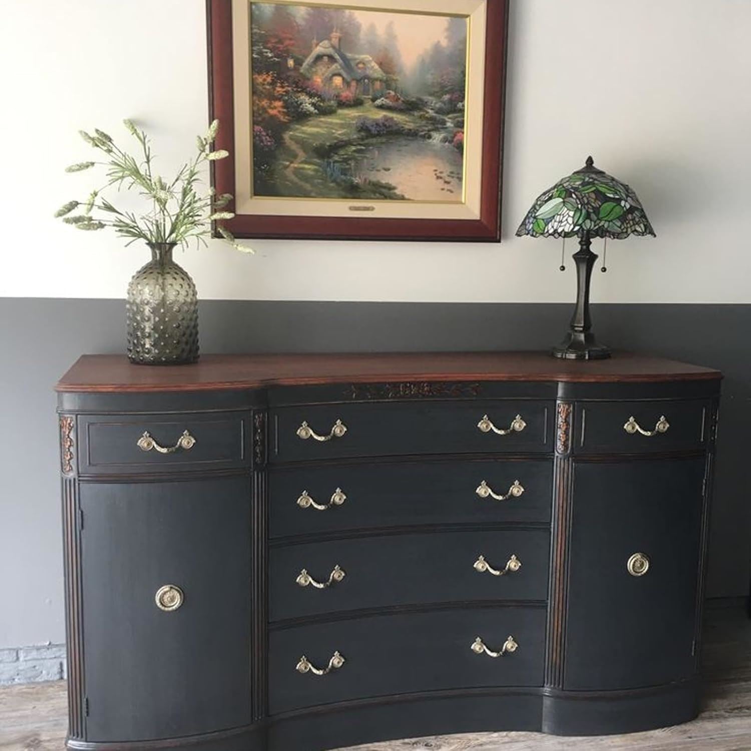 Nonslip black paint tin displayed next to a stylish wooden dresser and decorative items