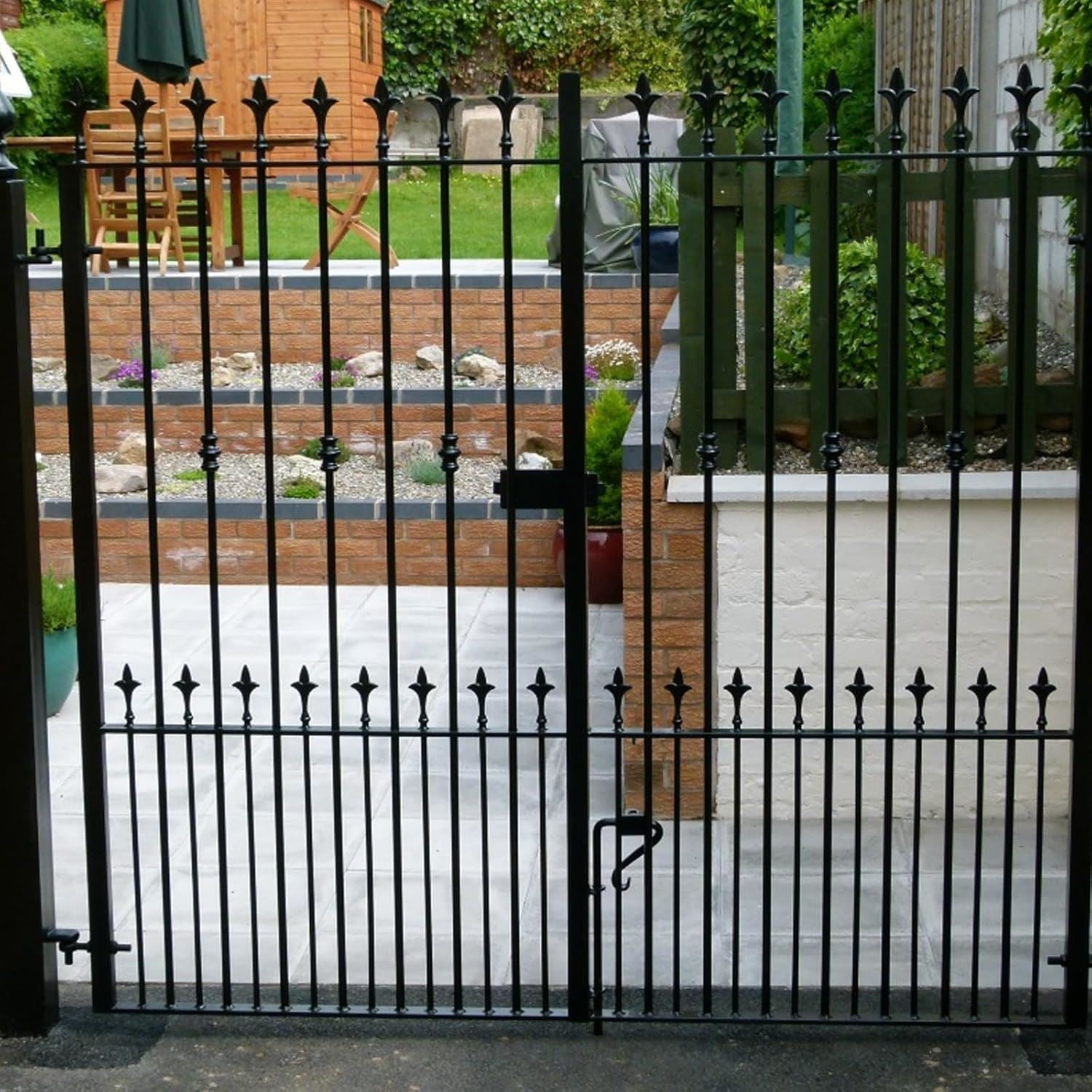 Iron gate in black gloss paint with decorative spikes for a stylish outdoor entrance