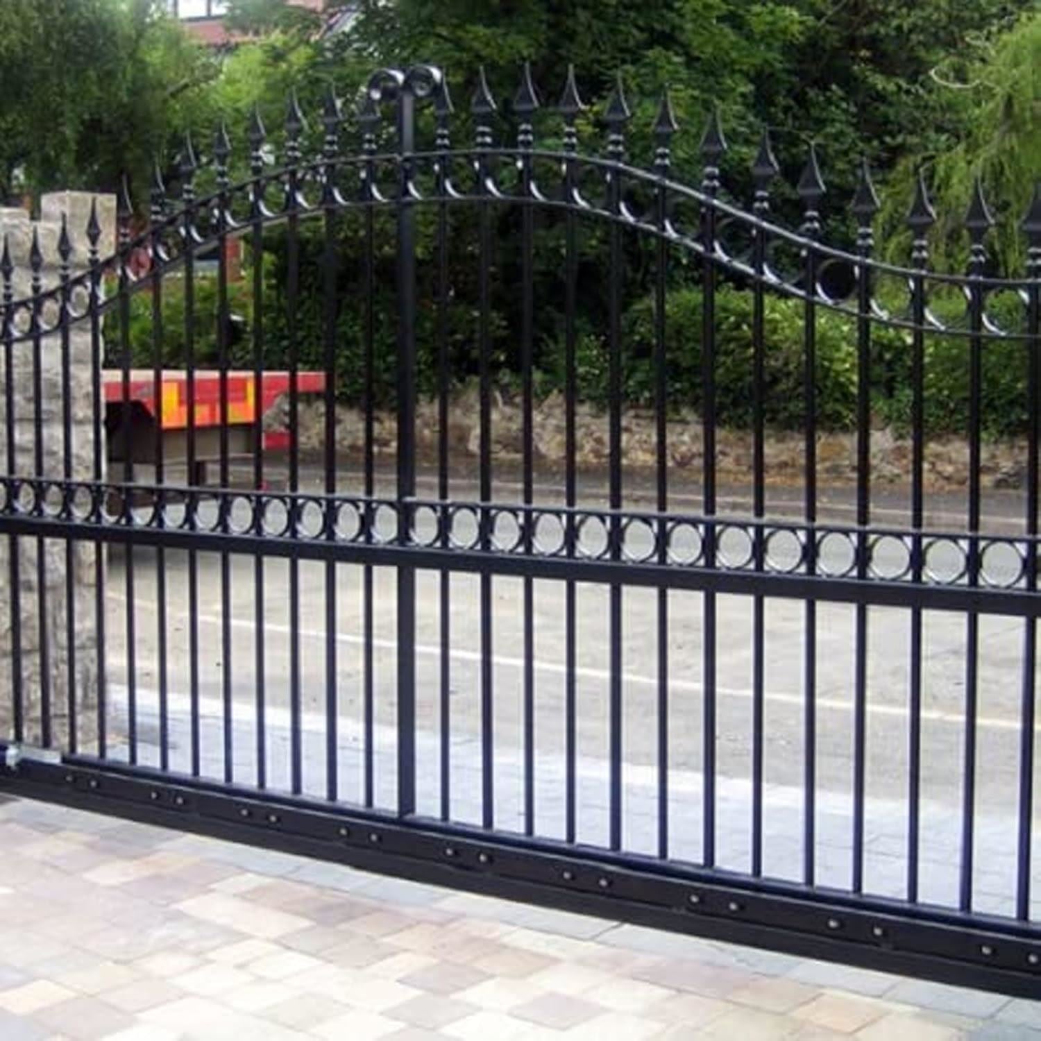 Stylish iron gate finished with black gloss paint for an elegant entrance.
