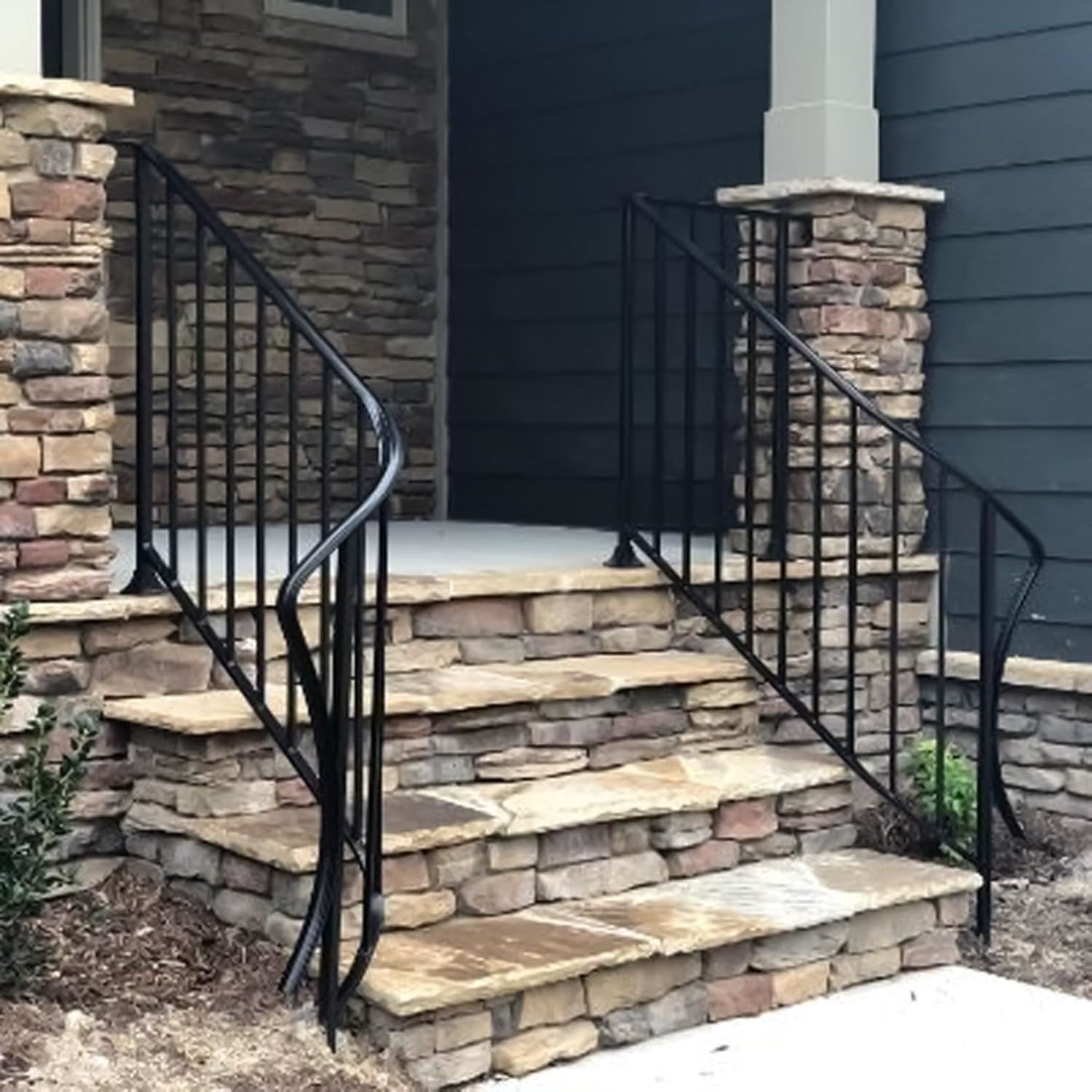 Stylish wrought iron handrails painted with iron gate black gloss paint for an elegant entrance