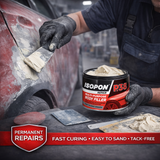 Person applying ISOPON P38 body filler to a car scratch with a container of the product in focus.