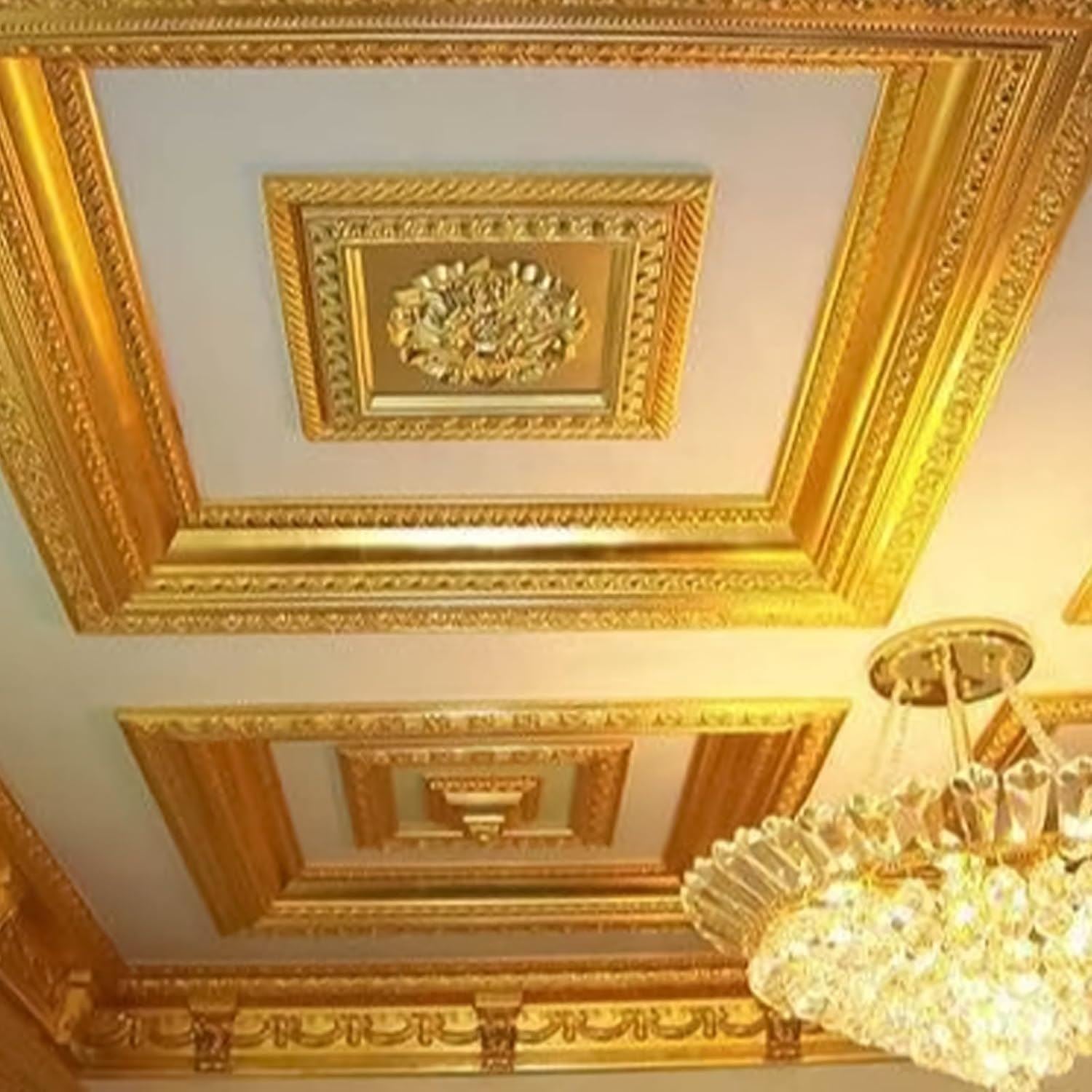 Intricate ceiling design featuring metallic gold paint tin accents and elegant chandelier lighting