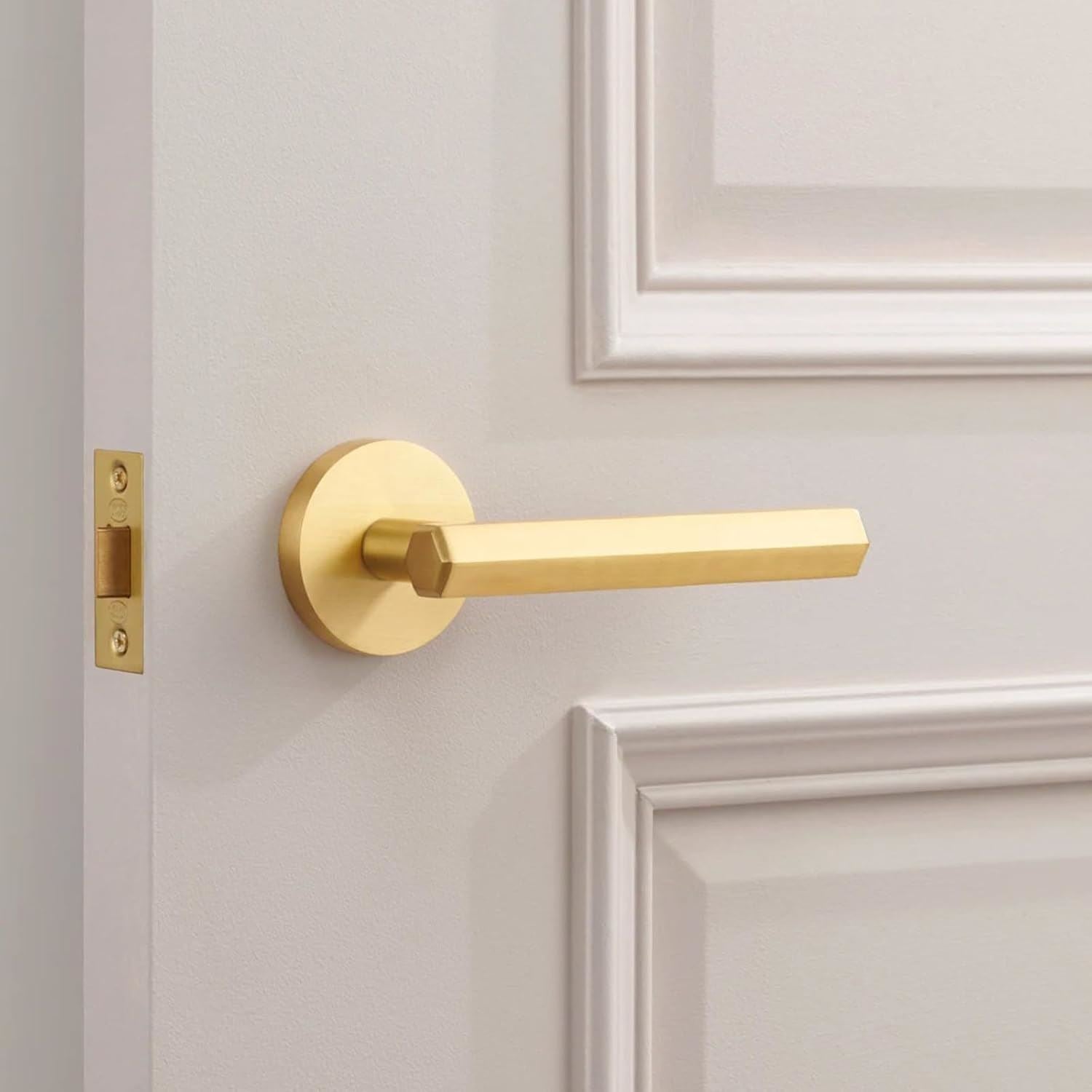 Stylish door handle in brushed metallic gold finish, perfect for modern home decor, beside a metallic gold paint tin