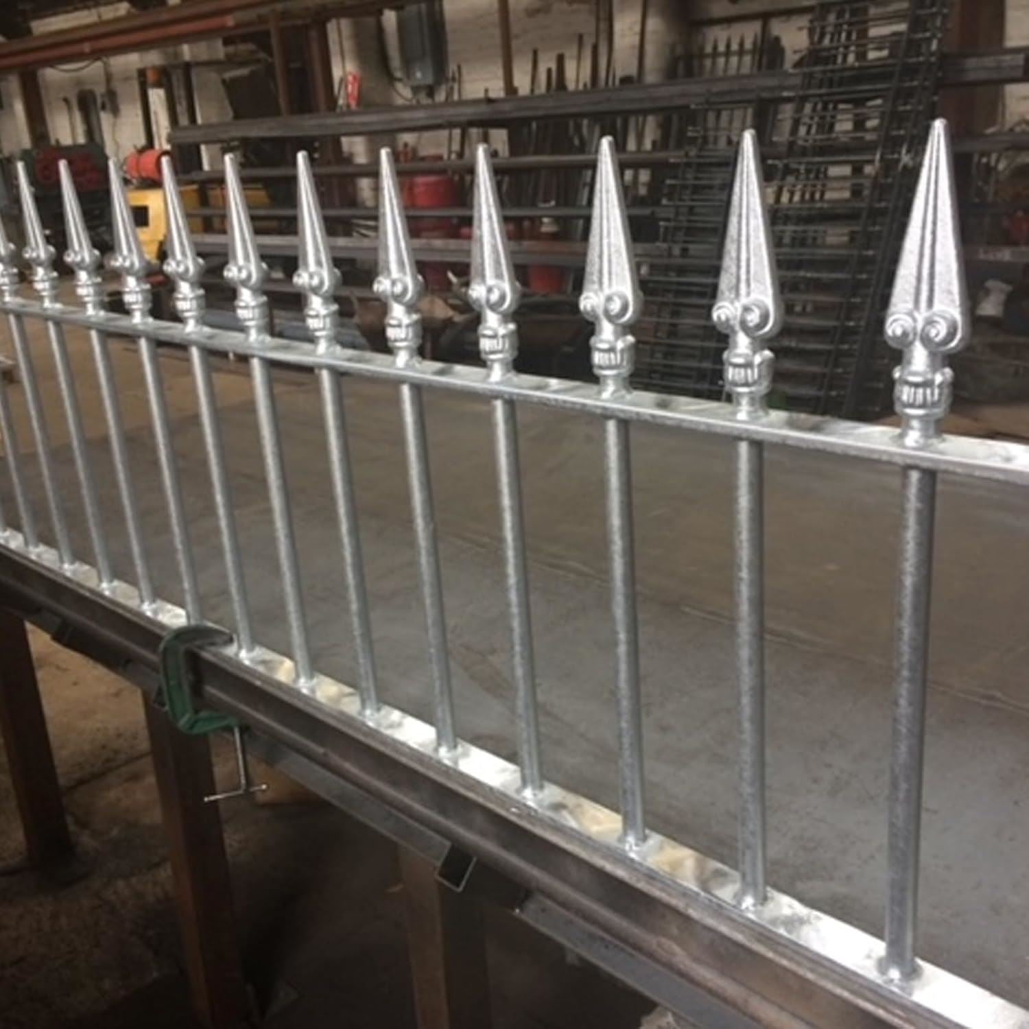 Metal fence with pointed tops finished in metallic silver paint tin for enhanced durability and style