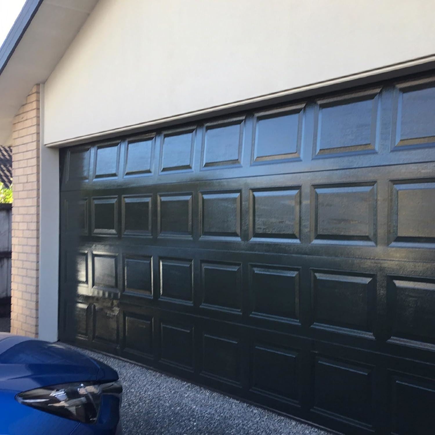 Non-drip black gloss paint tin by 151 with a glossy finish on a garage door
