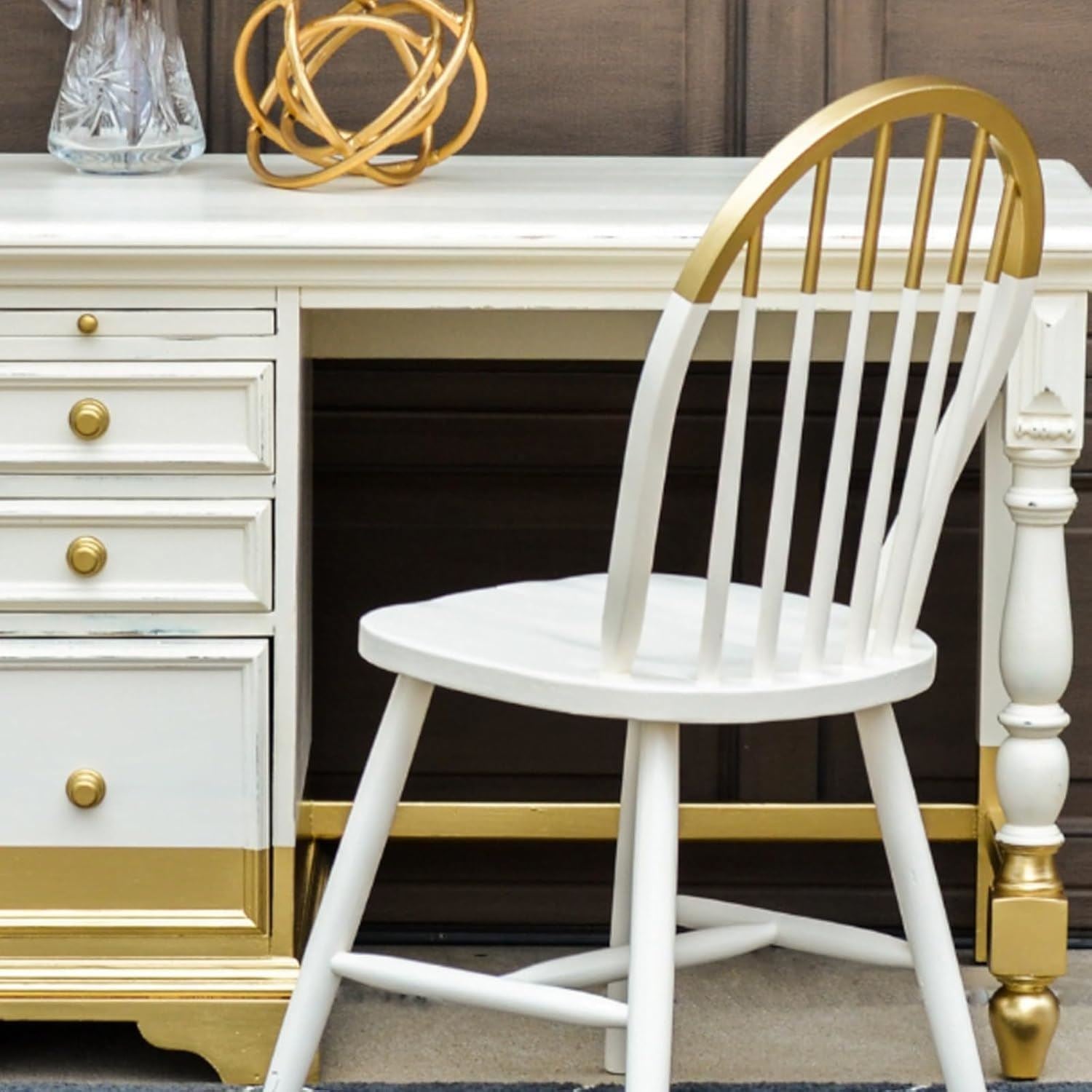 Elegant workspace featuring a wooden desk with metallic gold paint tin 300ml accents and a white chair