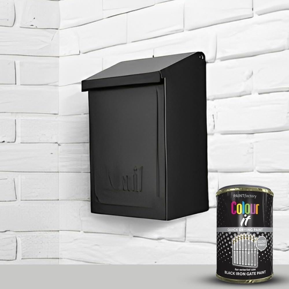Tin of black iron gate gloss paint by Paint Factory next to a black mailbox on a white brick wall